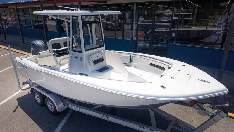 Slide: The Image of 2026 Tidewater 220 CC Adventure on a trailer. It features a center console and white seating. - 18