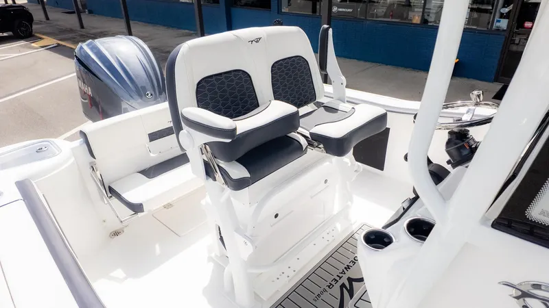 Slide: The Image of The image shows the seating area of a Tidewater 220 CC Adventure boat with modern, cushioned seats. - 11