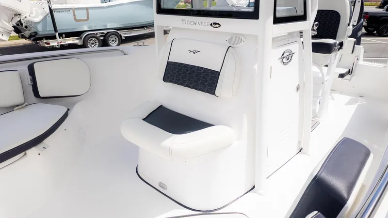 Slide: The Image of The image shows the cockpit of a Tidewater 220 CC Adventure boat with white and black seating. - 18