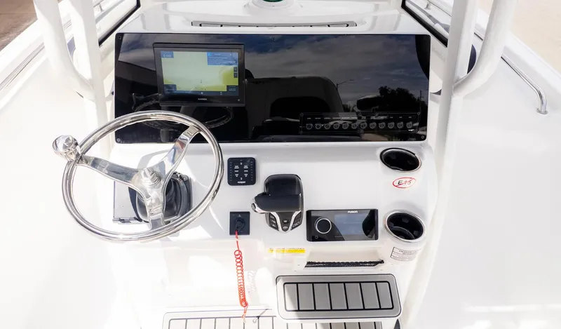 Slide: The Image of The image shows the helm of a Tidewater 220 CC Adventure boat with a modern navigation system. - 13