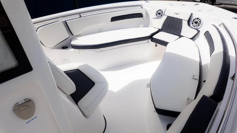 Slide: The Image of The image shows the interior of a Tidewater 220 CC Adventure boat with sleek white seating. - 12