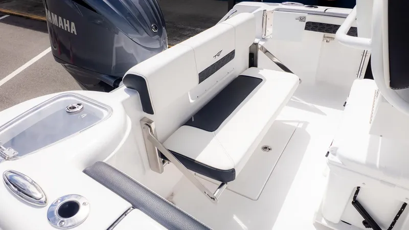 Slide: The Image of The image shows the cockpit of a Tidewater 220 CC Adventure boat with a white bench seat. - 5
