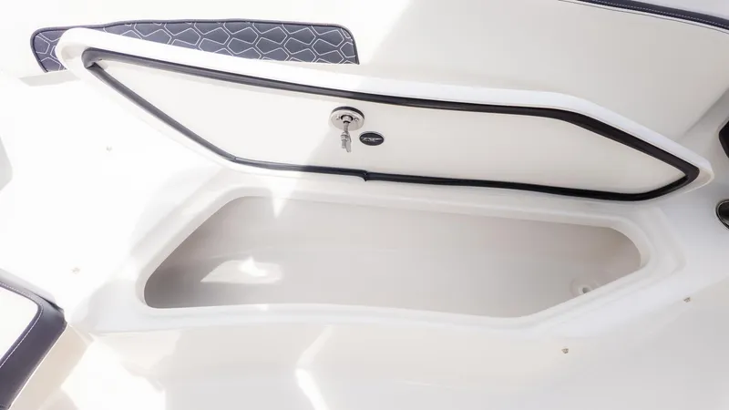 Slide: The Image of An open storage compartment on a boat with a cushioned seat nearby. - 16