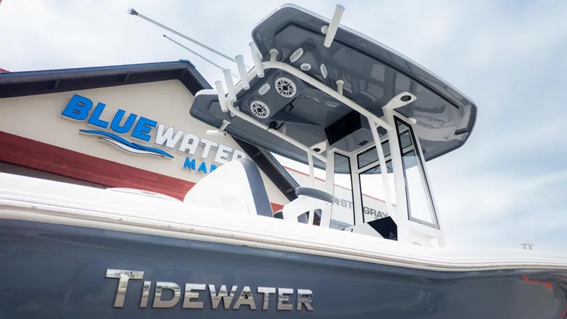 The Image of Tidewater 220 CC Adventure boat in front of a building with Bluewater logo. - 1