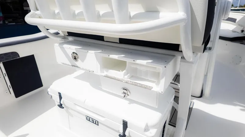 Slide: The Image of The image shows the storage area and cooler of a Tidewater 220 CC Adventure boat. - 7