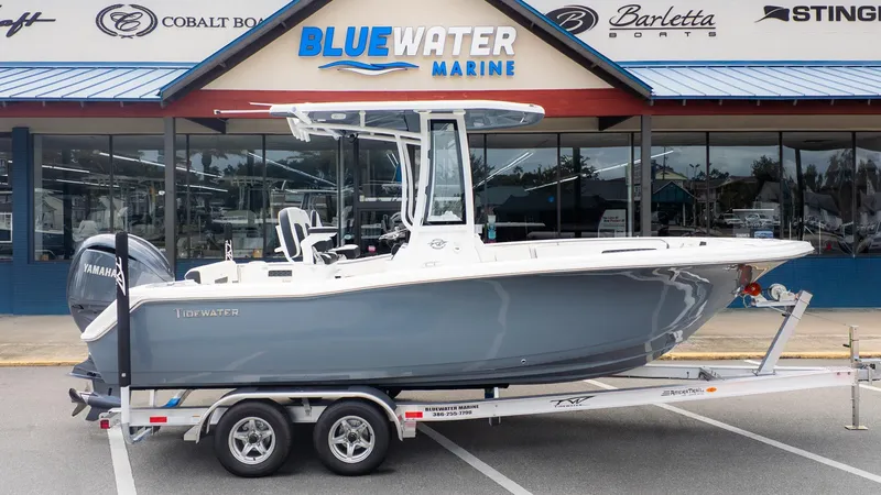 Slide: The Image of 2026 Tidewater 220 CC Adventure on a trailer in front of a marine dealership. - 19
