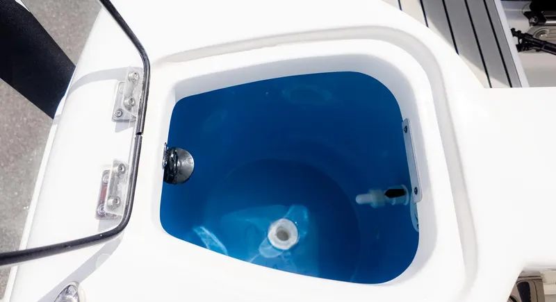 Slide: The Image of A view into the blue interior of a boat tank with a white rim. - 5