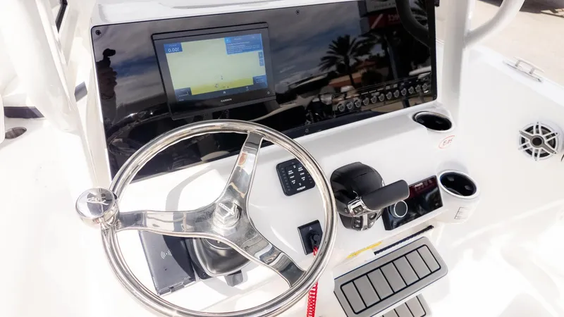 Slide: The Image of The image shows the helm of a Tidewater 220 CC Adventure boat with a modern navigation system. - 12