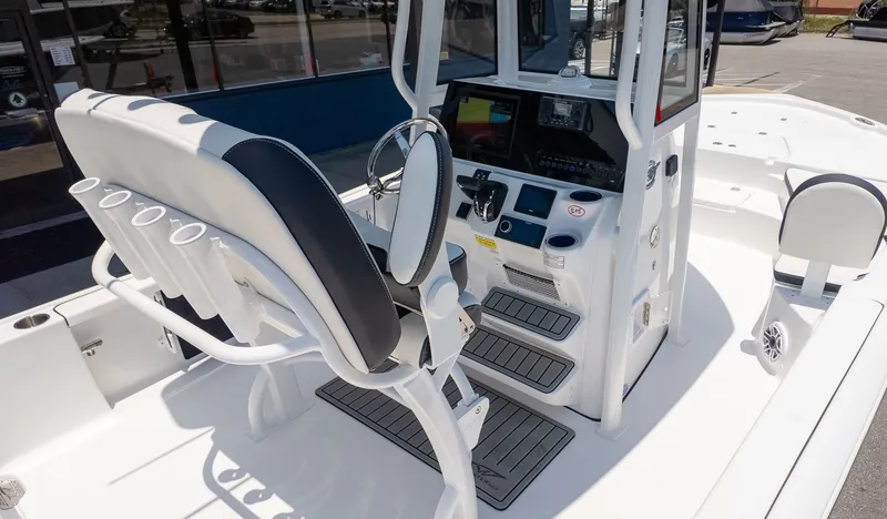 Slide: The Image of The image shows the cockpit of a Tidewater 2210 Carolina Bay boat with modern controls. - 12