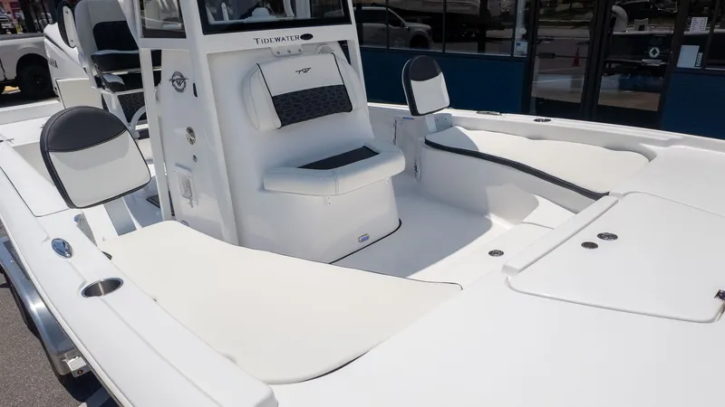 Slide: The Image of The image shows the cockpit of a Tidewater 2210 Carolina Bay boat with white upholstery. - 16