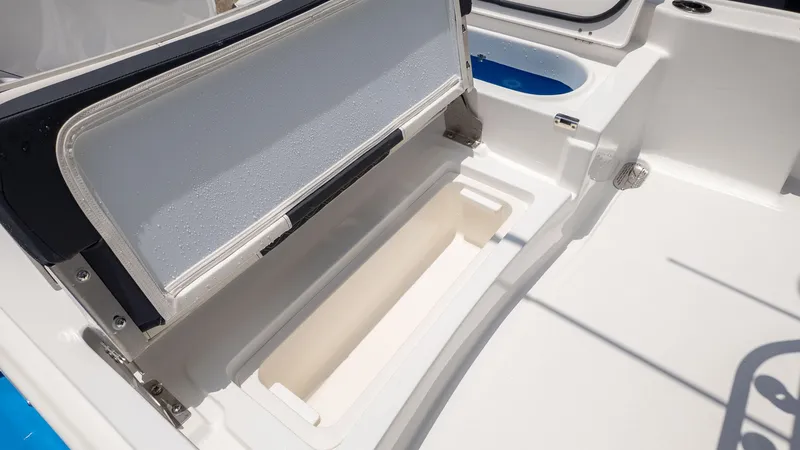 Slide: The Image of The image shows the storage compartment of a 2027 Tidewater 2210 Carolina Bay boat. - 7