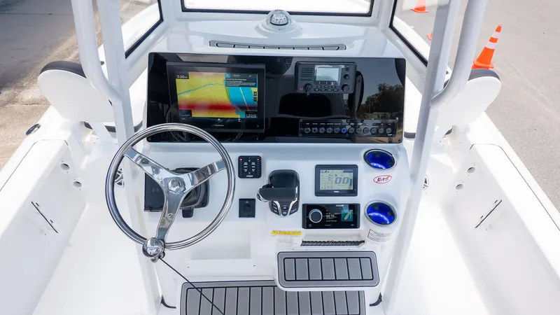 Slide: The Image of The image shows the helm of a 2027 Tidewater 2210 Carolina Bay boat with modern instruments. - 14