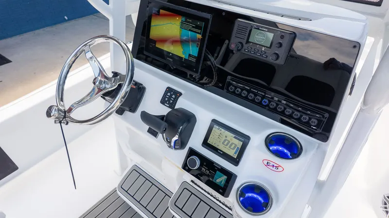 Slide: The Image of The image shows the helm of a Tidewater 2210 Carolina Bay boat with modern instruments. - 13