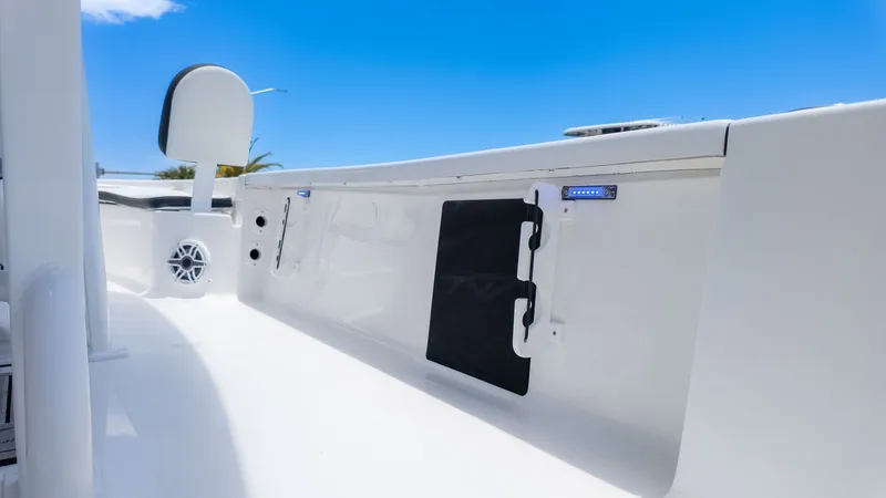 Slide: The Image of The image shows the deck of a Tidewater 2210 Carolina Bay boat under a blue sky. - 9