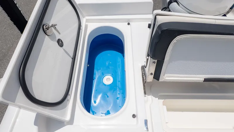 Slide: The Image of The image shows a boat with a blue livewell and a cushioned seat. - 6