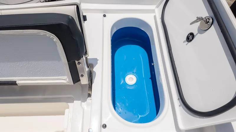 Slide: The Image of A boat with a blue, oval storage compartment and a cushioned seat. - 8