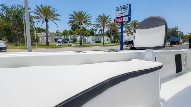 Slide: The Image of The image shows the interior of a Tidewater 2210 Carolina Bay boat with white seating. - 16