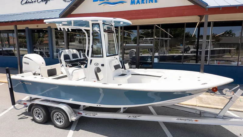 The Image of A 2027 Tidewater 2210 Carolina Bay boat on a trailer in front of a store. - 1