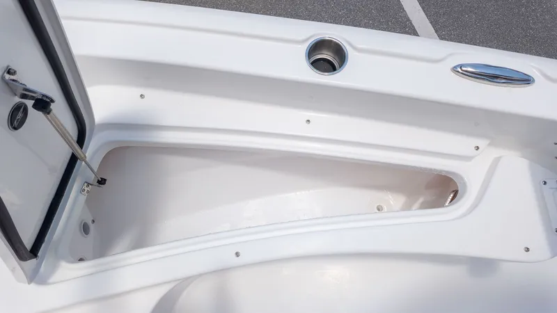 Slide: The Image of An open storage compartment on a boat with a white interior and stainless steel fittings. - 16