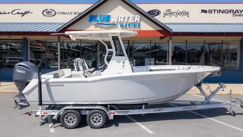 Slide: The Image of A white Tidewater 232 LXF boat on a trailer in front of a boat dealership. - 21