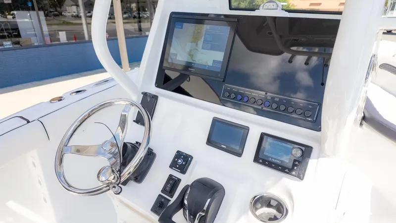 Slide: The Image of The image shows the helm of a Tidewater 232 LXF boat with modern instruments and a screen. - 13