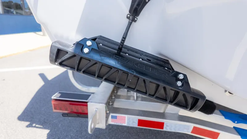 Slide: The Image of Close-up of a boat trailer with a black bumper and an American flag. - 4