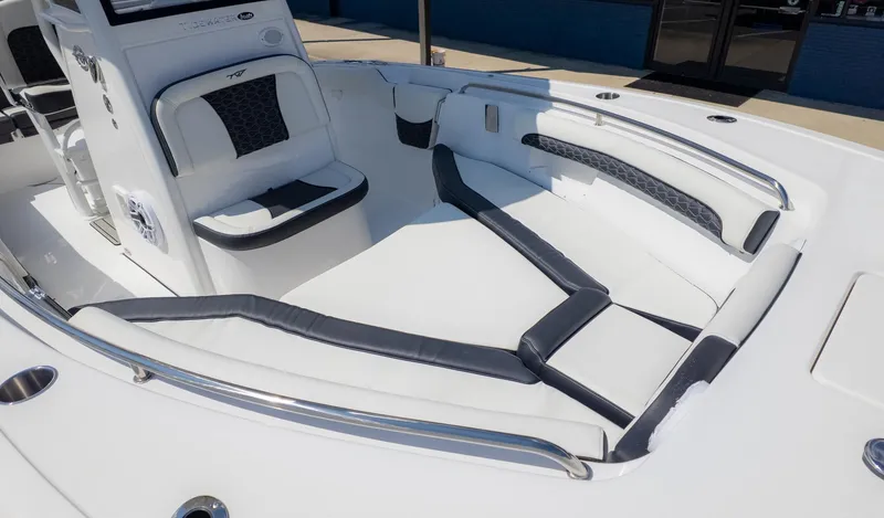 Slide: The Image of The image shows the cockpit of a Tidewater 232 LXF boat with white and black upholstery. - 18