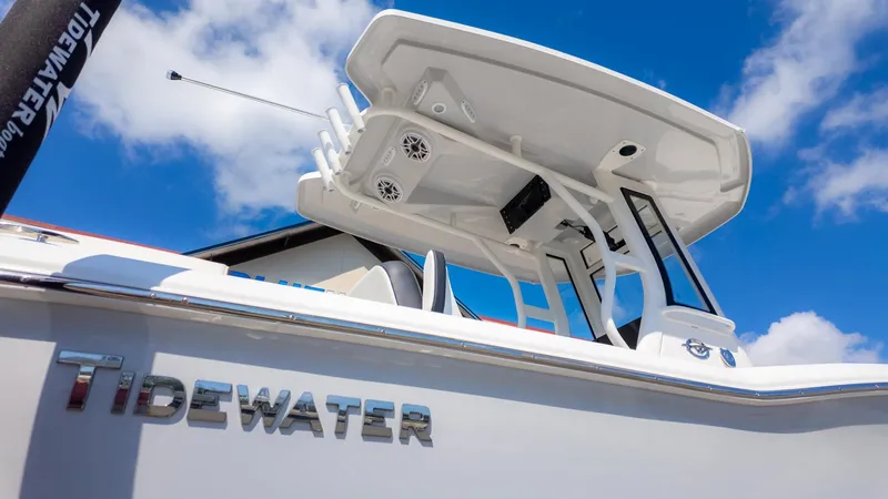 Slide: The Image of Close-up of a white Tidewater 232 LXF boat with T-top and speakers. - 21