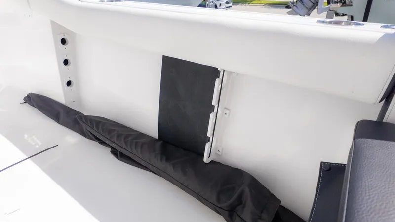Slide: The Image of Interior view of a boat with a white hull and black cover. - 6