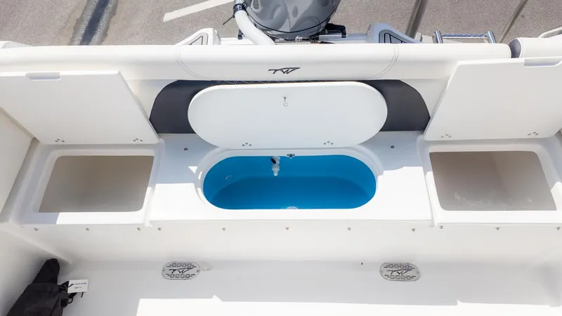 Slide: The Image of The image shows the stern of a Tidewater 232 LXF boat with storage and a blue water container. - 5