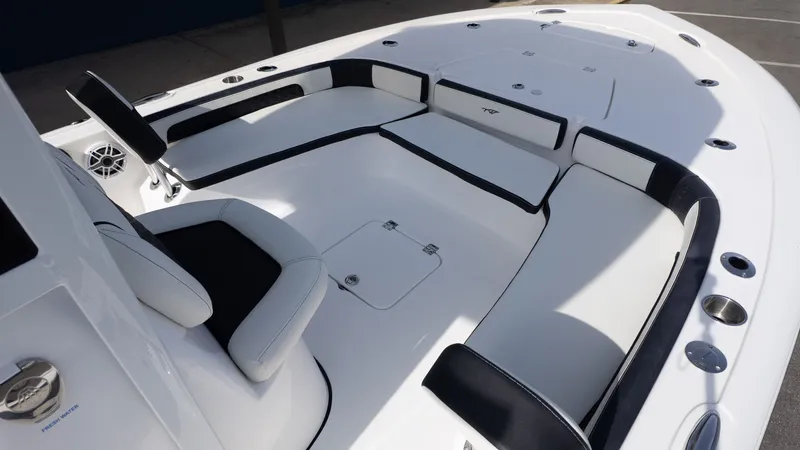 Slide: The Image of The image shows the deck of a Tidewater 2300 Carolina Bay boat with white and black seating. - 17