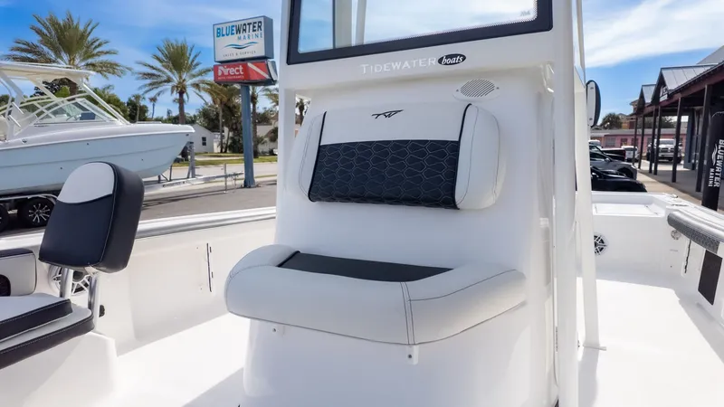 Slide: The Image of The image shows the cockpit of a Tidewater 2300 Carolina Bay boat with cushioned seating. - 24