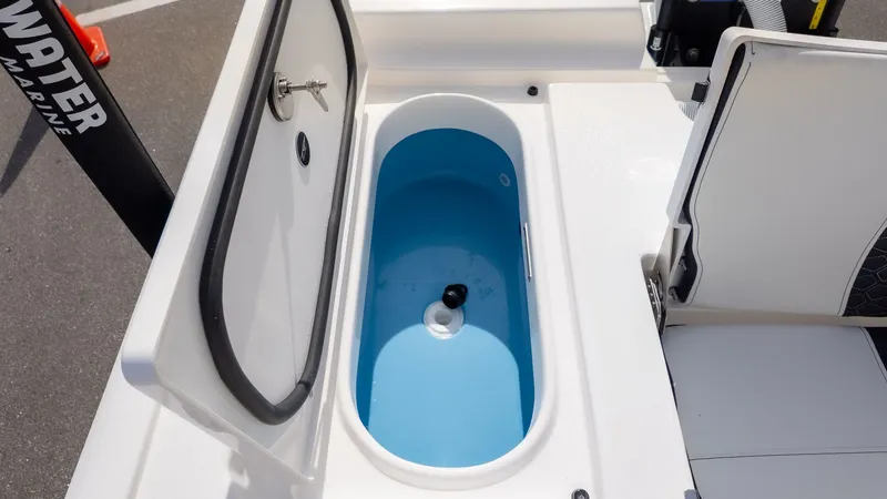 Slide: The Image of An open storage compartment on a boat with a blue interior and a drain. - 8