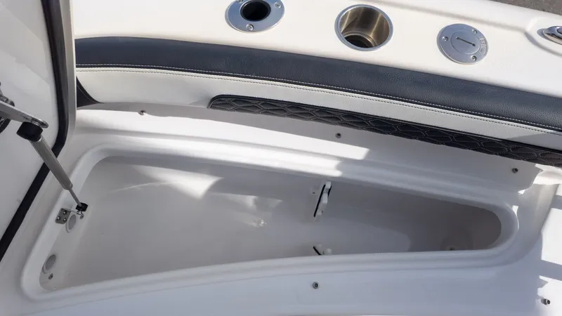 Slide: The Image of An open storage compartment on a boat with padded edge and stainless steel fittings. - 19