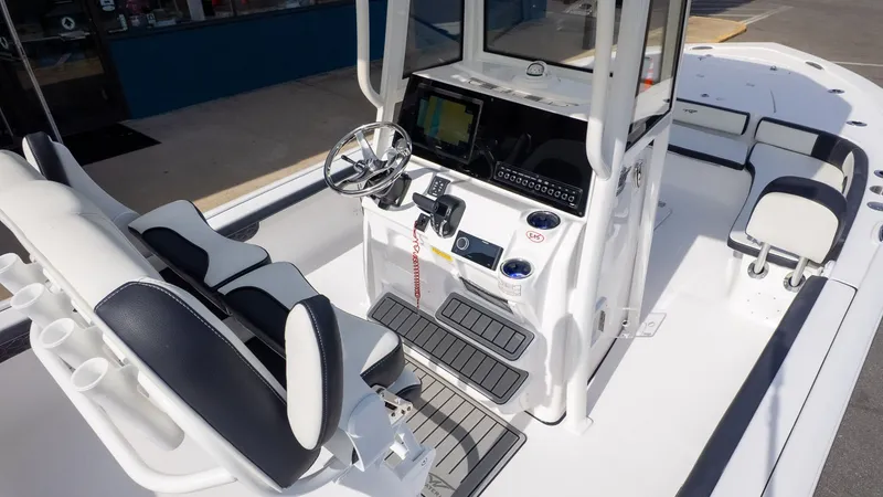 Slide: The Image of The image shows the cockpit of a Tidewater 2300 Carolina Bay boat with modern controls. - 12