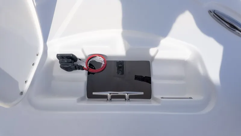 Slide: The Image of A white boat with a black compartment lid and a red cable. - 20