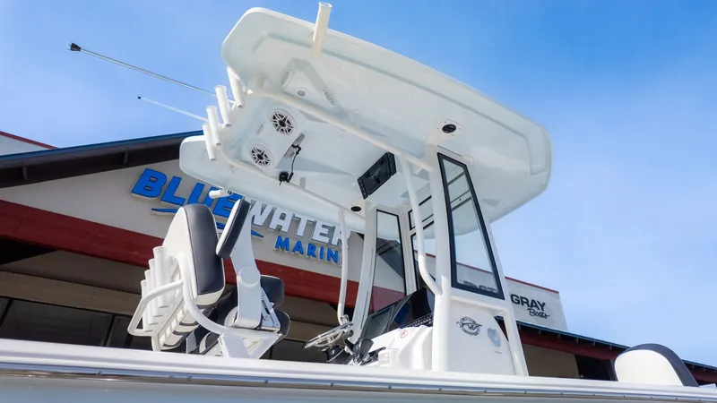 Slide: The Image of The image shows a modern boat with an elevated helm and speakers, in front of a building. - 25