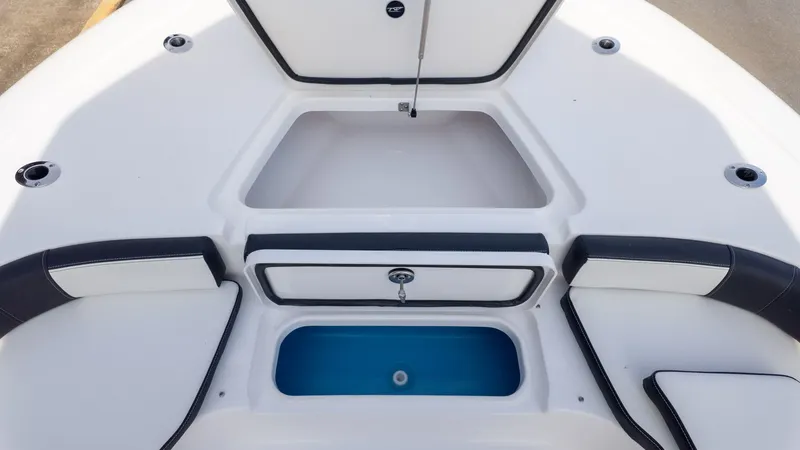 Slide: The Image of The image shows the bow area of a Tidewater 2300 Carolina Bay boat with storage and seating. - 19