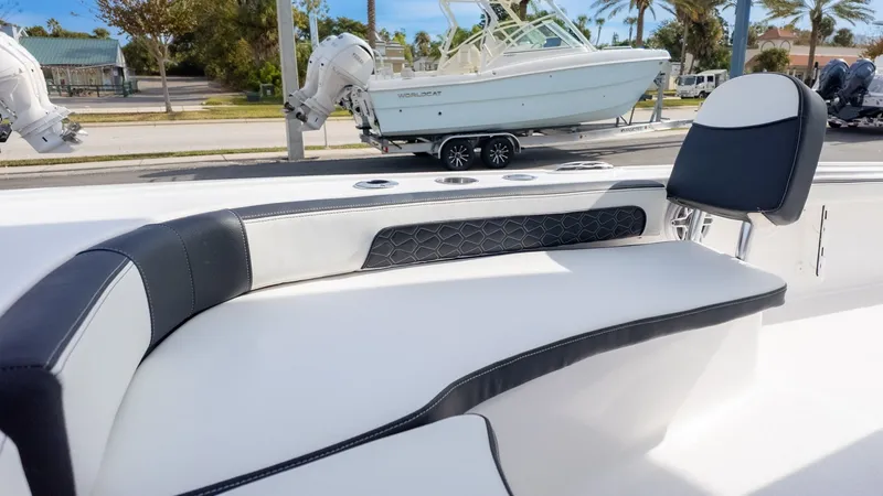 Slide: The Image of The image shows the sleek, cushioned seating area of a Tidewater 2300 Carolina Bay boat. - 16