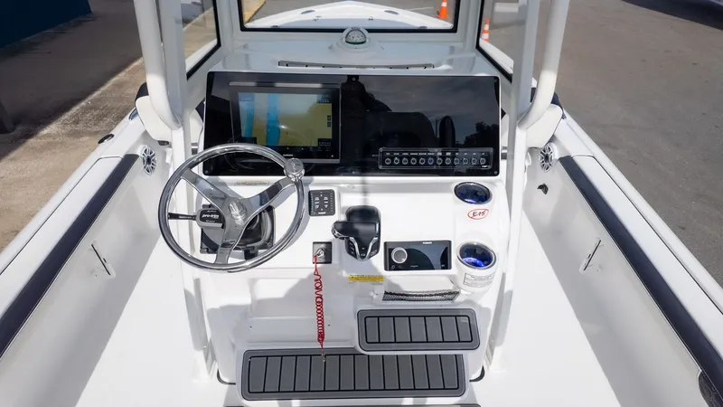 Slide: The Image of The image shows the helm of a Tidewater 2300 Carolina Bay boat. - 11