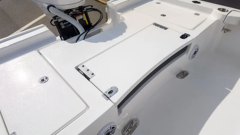 Slide: The Image of The image shows the deck of a Tidewater 2300 Carolina Bay boat with storage compartments and speakers. - 7