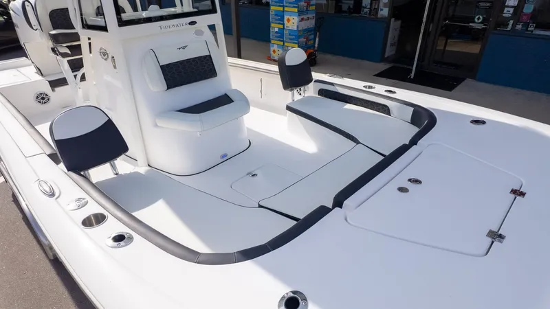 Slide: The Image of The image shows the deck of a Tidewater 2300 Carolina Bay boat with white upholstery. - 21