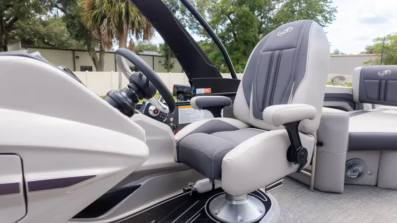 Slide: The Image of The image shows the helm of a 2025 Barletta Corsa 23M with a cushioned captain's chair. - 29