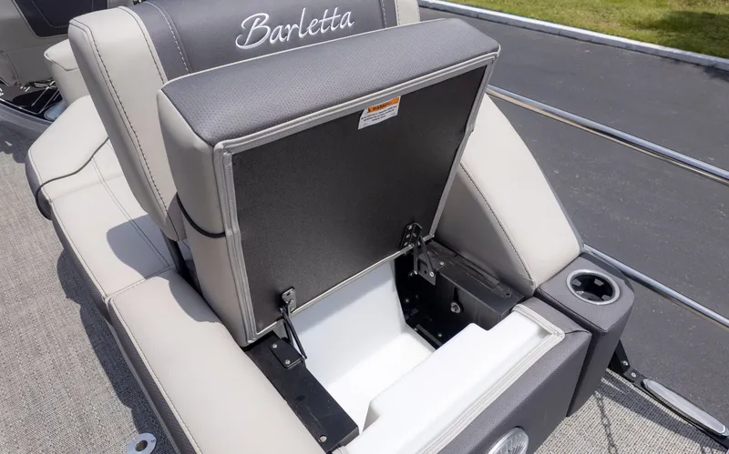 Slide: The Image of The image shows a seating area on a Barletta Corsa 23M boat with storage underneath. - 16