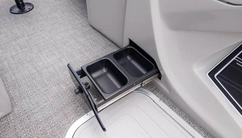 Slide: The Image of A pull-out cup holder on a carpeted boat floor. - 27