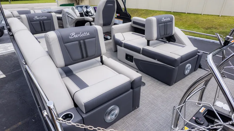 Slide: The Image of The image shows the interior of a Barletta Corsa 23M pontoon boat with gray and white seating. - 7