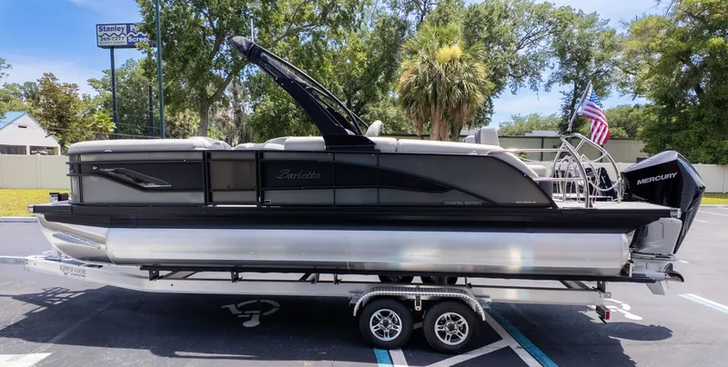 Slide: The Image of 2025 Barletta Corsa 23M on a trailer, featuring an American flag and Mercury engine. - 5
