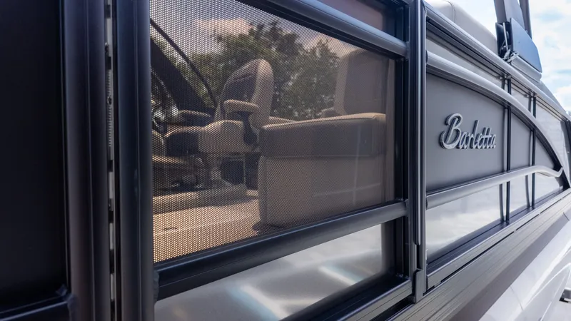 Slide: The Image of Close-up of the Barletta Corsa 23M, showing seats through a mesh window. - 4