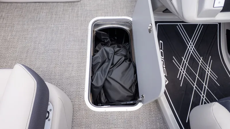 Slide: The Image of An open storage compartment on a boat with a black cover inside. - 28