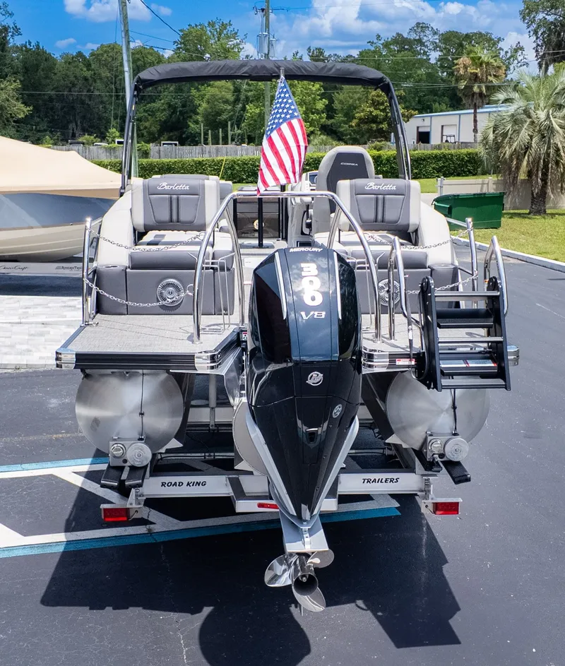 Slide: The Image of The image shows a 2025 Barletta Corsa 23M pontoon boat with a Mercury outboard motor. - 5